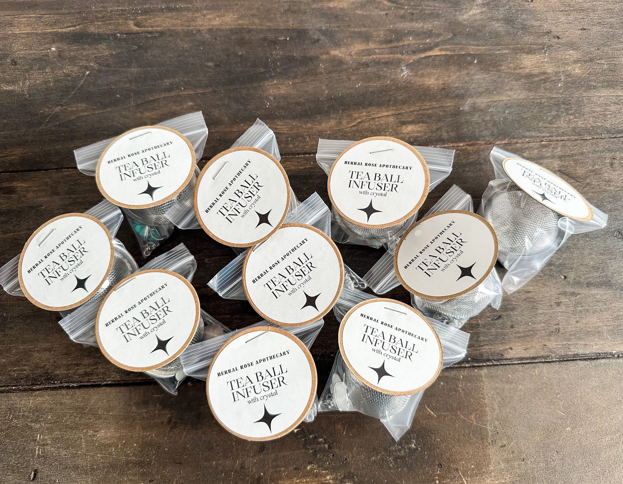 several tea ball infusers packaged in plastic bags with paper labels attached